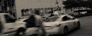 live your life sign with blurred cars in front